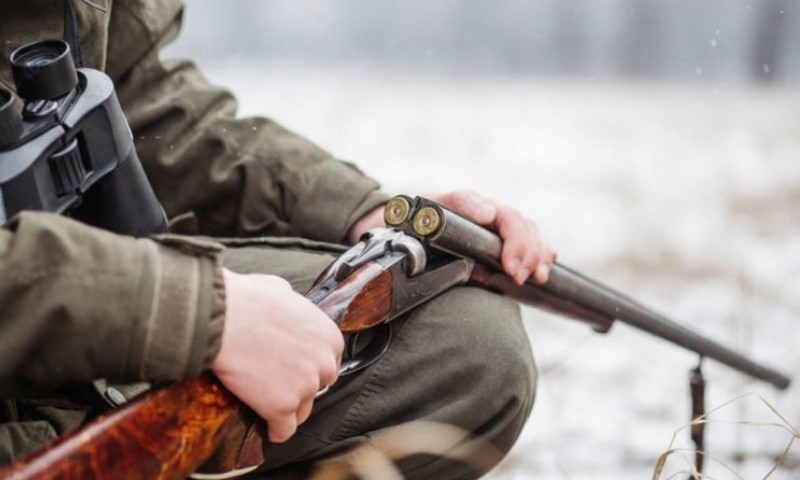 Muškarac s puškom u snegu